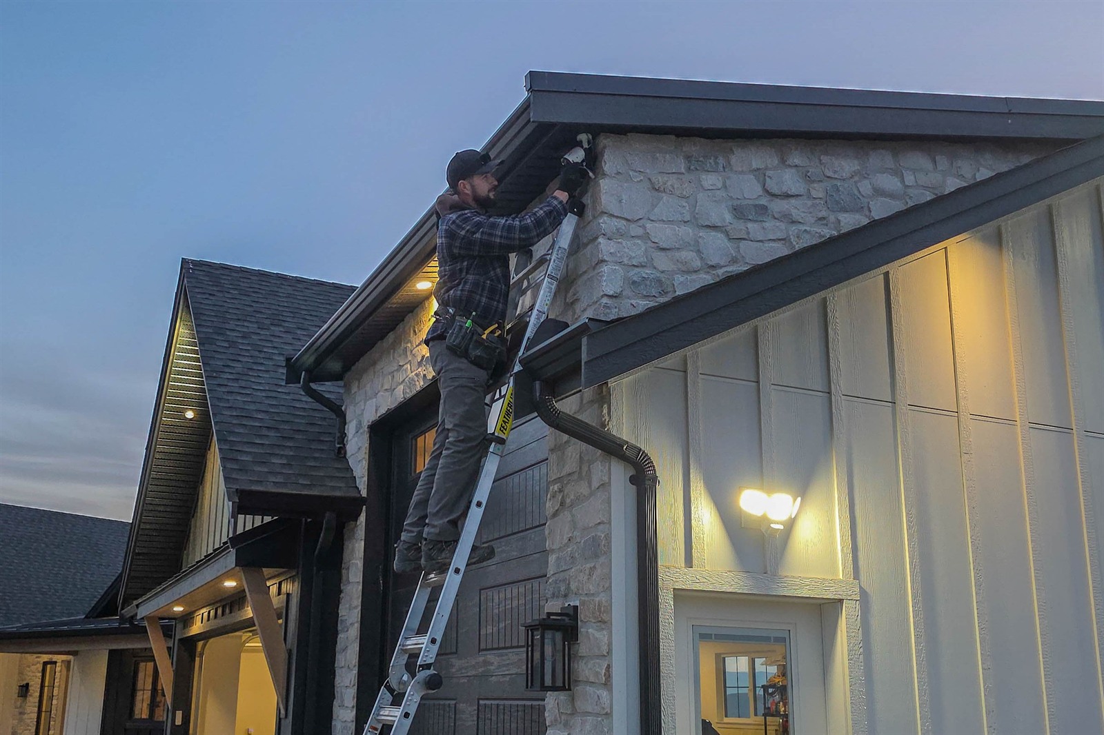 Sona HomeTech technician installing exterior security equipment